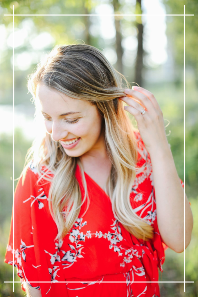 close up of Hannah smiling in a red floral romper